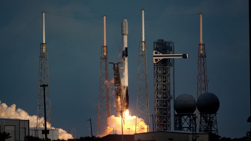 Spectacular shot of a Space Rocket blasting off from launch pad as it flies to space on its mission to place communication satellites in earth orbit. 4K. Slow-motion. Includes sound and audio.