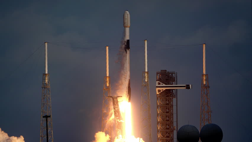 Spectacular shot of a Space Rocket blasting off from launch pad as it flies to space on its mission to place communication satellites in earth orbit. 4K. Slow-motion. Includes sound and audio.