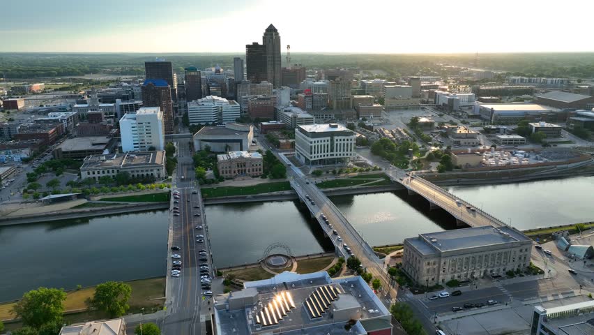 Sunset in Des Moines, Iowa. Aerial establishing shot high above Des Moines River and cityscape.