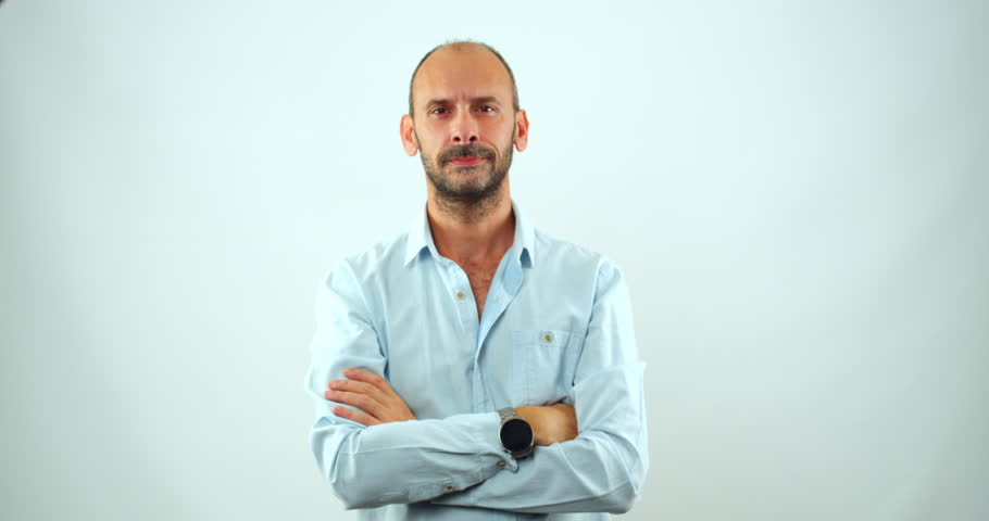 A middle-aged  man looks at the camera and smiles in slow motion