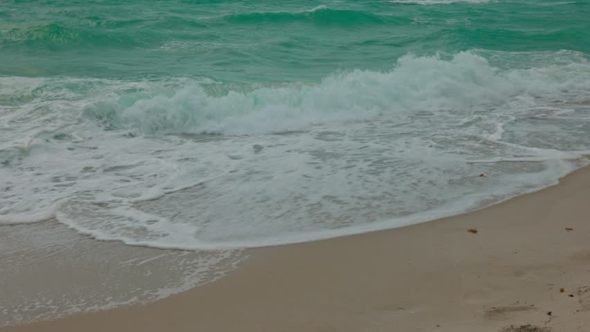 Stormy day at Miami Beach, with crashing waves Atlantic ocean, sandy shores, and birds in flight.  | Shutterstock HD Video #1111353913