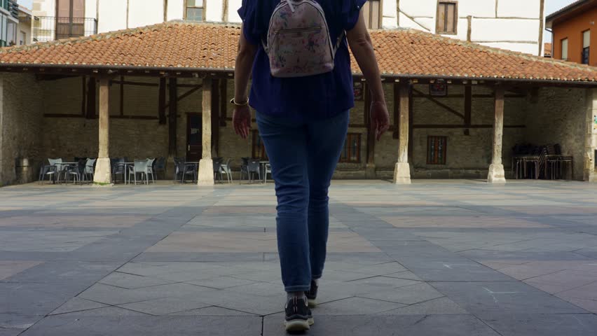 Female tourist strolling through the streets of the Basque village of Salvatierra in northern Spain.
