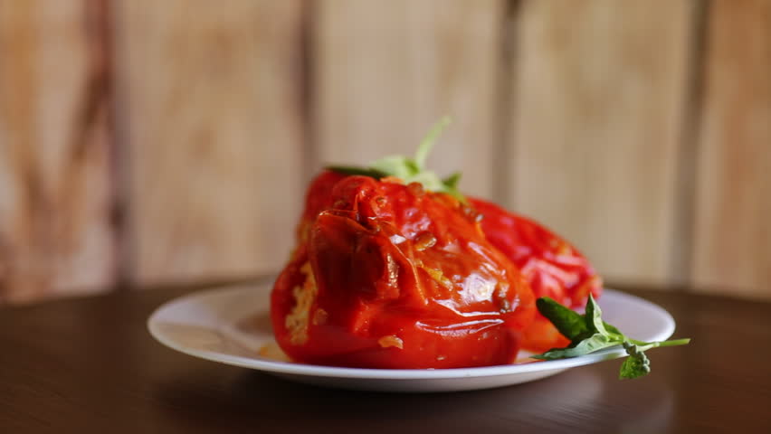 stewed in gravy stuffed peppers in a plate .