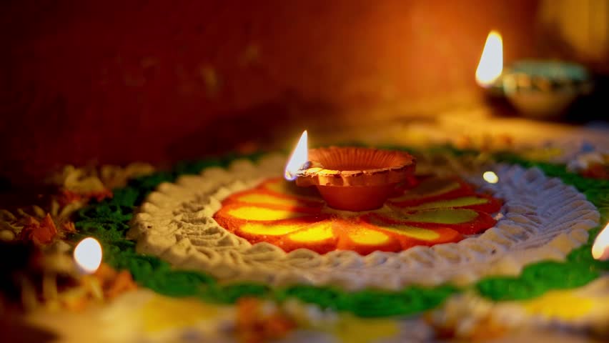 diwali diya or oil lamp lit on colorful rangoli. closeup shot of diwali diya  - Powered by Shutterstock - Get 15% off with code: PIKWIZARD15
