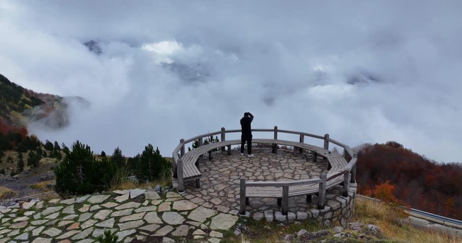 A photographer taking photos of a cloudy landscape of Thethi national park, northern Albania.