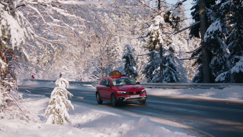 TRACKING Family driving home with a Christmas tree tied to a roof of a generic red car against beautiful mountain landscape | Shutterstock HD Video #1111372291