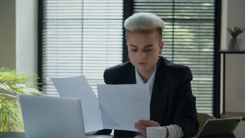 Concept of paperwork at the office. Alone secretary woman sitting till the night to end job in time. Serious businesswoman check financial diagrams of the company. Agreements review. Lawyer fix Royalty-Free Stock Footage #1111372969