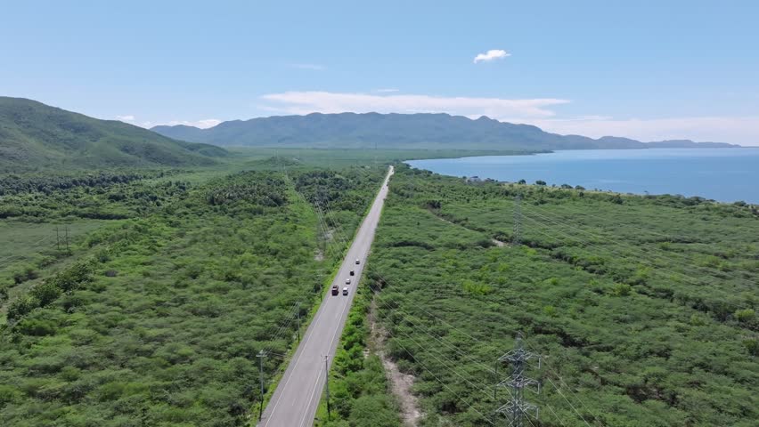 Scenic long road through tropical rainforest lane on Caribbean island, drone