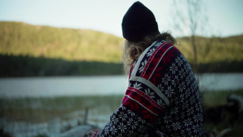 Long-Haired Norwegian Guy Drinking Coffee Outdoor With Nature Background. Medium Shot