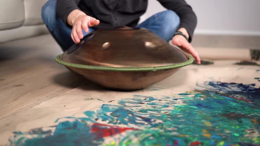 Hands with hang drum close up, man practicing meditation music 