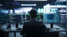 Back View of a Young Engineer Working on Computer in a Technological Office Environment. Male Programmer Writing Software Code for a Blockchain Project, Developing Backend System. Zoom Out - Powered by Shutterstock - Get 15% off with code: PIKWIZARD15