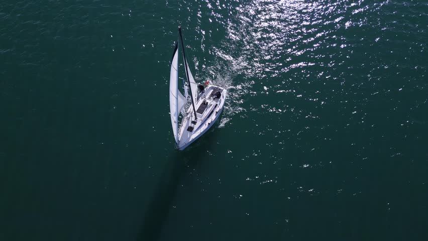 A yacht with all sails set races across the sea, propelled by the wind. Aerial view Royalty-Free Stock Footage #1111382795