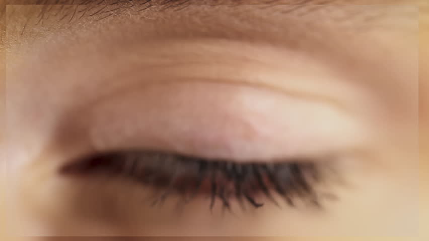 
Beautiful Macro Shot of Green Woman Eye Blinking. Pupil Opening. Zoom in to a Back Frame. Healthy Eyesight concept. Make up.