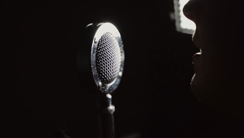 Hate speech concept - very angry screaming in a microphone in the dark | Shutterstock HD Video #1111385957