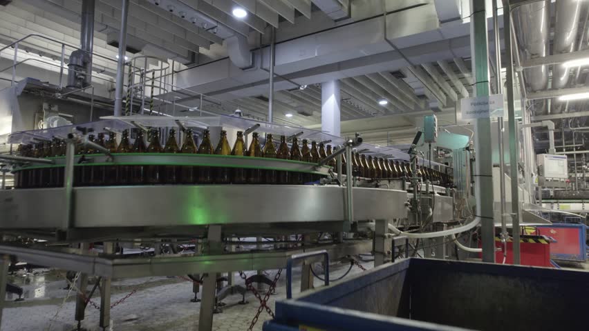 beer bottles and cans on a production line in a beer factory