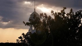 Reveal of Old Main during sunset at the University of South Dakota in Vermillion, SD - Powered by Shutterstock - Get 15% off with code: PIKWIZARD15