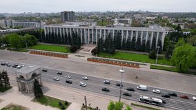 Panoramic aerial drone view of Triumphal Arch, Great National Assembly Square with Government Building of Republic of Moldova on background in Boulevard Stefan cel Mare of Chisinau, Moldova. 4K video