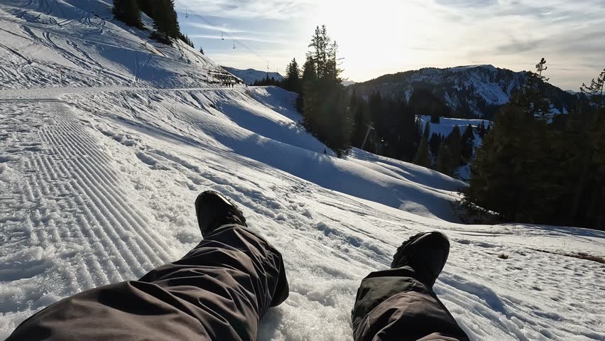 Legs view of young man looking the sunset while sitting on snow high mountains - Winter vacation and travel influencer concept Royalty-Free Stock Footage #1111394989