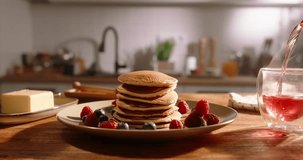 Unknown person pours tea in cup, pancakes with berries. No people, advertising, cinematic. Art of healthy tasty food, gluten-free recipes and delectable gluten-free options. Excess sugar, diabetes