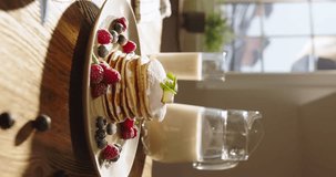 American traditional breakfast pancakes against backdrop of cozy kitchen. Sharing healthy eating gluten-free sugar-free recipes, gluten-free food. Dessert cheat meal. Vertical video, advertising.