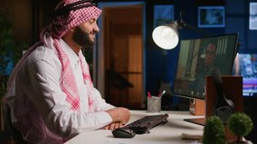 Muslim worker in video call session with therapist, asking for advice, feeling down. Remotely working Middle Eastern employee in internet consultation with psychologist from stylish cozy home