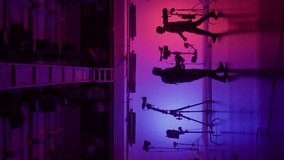 Professional filming pavilion with a neon cyclorama. The process of preparing for the shooting of a music video. Director, Cameraman and crew in Backstage. Vertical video - Powered by Shutterstock - Get 15% off with code: PIKWIZARD15