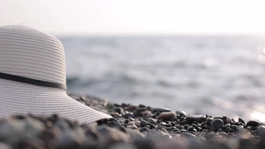 Summer vacation by the sea. A hat on the sand. Relaxation | Shutterstock HD Video #1111413047