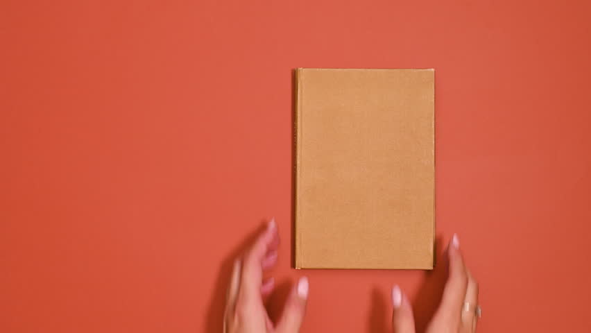 Artistic Unveiling: Woman Creatively Opens Vintage Book