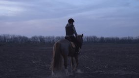 slow-motion video of a woman riding a horse in the Argentinean flat countryside