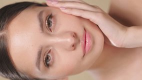 Beautiful young Woman with lean fresh skin. Girl beauty face care. Facial treatment . Cosmetology , beauty and spa. Slow motion. Vertical video - Powered by Shutterstock - Get 15% off with code: PIKWIZARD15