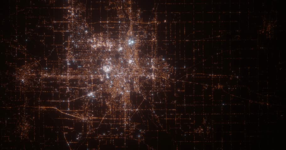 South Bend (Indiana, USA) top view at night. Aerial view on modern city from space. Camera is flying above the city, moving forward. Vertical video. The north is on the left side