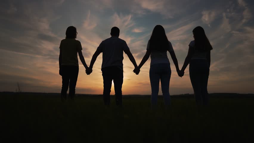Silhouette of group of people. People holding hand together symbol of unity and helping hand in business. Teamwork unity freedom people. Team of people holding hands together support success victory Royalty-Free Stock Footage #1111423915