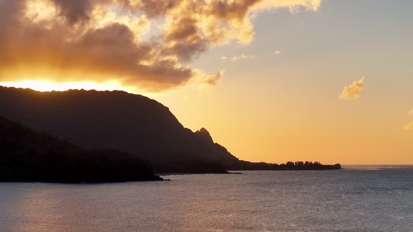 Aerial Hanalei bay mountain sunset beach Kauai Hawaii evening. Surfing and swimming ocean recreation. Bay cove for swimming, snorkel and surfing from sandy beach and boat pier. Garden Isle. Economy.