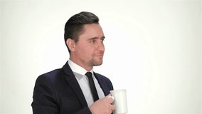 Formally dressed businessman drink from a cup, smiling and showing thumb - Powered by Shutterstock - Get 15% off with code: PIKWIZARD15