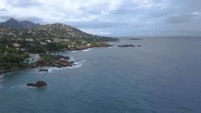 Aerial video of the Agay bay on the French Riviera. In the footage can be seen a panorama of the bay, with mountains in the background. Video was shot on a cloudy day.