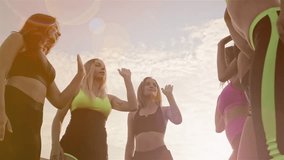 Six Happy Healthy Women Giving High Five Gesture While Relaxing After an Outdoor Exercise at the Park. Group of fit happy people celebrating success. Teamwork, unity, support, motivation, active - Powered by Shutterstock - Get 15% off with code: PIKWIZARD15