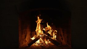 Burning Fire In The Fireplace. Slow Motion. A Looping Clip of a Fireplace with Medium Size Flames Winter and Christmas Holidays Concept