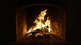 Fireplace Screen Sarver. Wood Burning in a Cozy Fireplace. Slow Motion Video of Burning Wooden Logs. A Looping Clip of Fire Flames for Meditation. Christmas time.