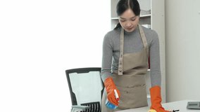 Asian woman cleaning house, housekeeper cleans and wipes messy mess in living room at home