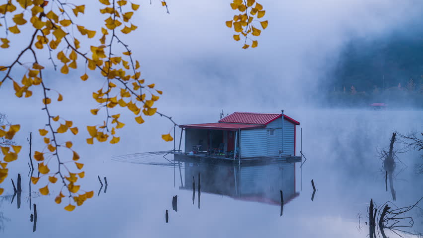Autumn leaves in Korea.Beautiful morning light and a hut in the middle of a misty lake in South Korea. The leaves change beautiful colors.