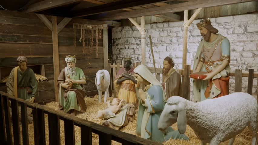 Religious Christian sculptures of the Nativity scene in outdoors fair or market. Famous scene from Christian Bible of birth of Christ depicted by life-size figures in Christmas market in Austria