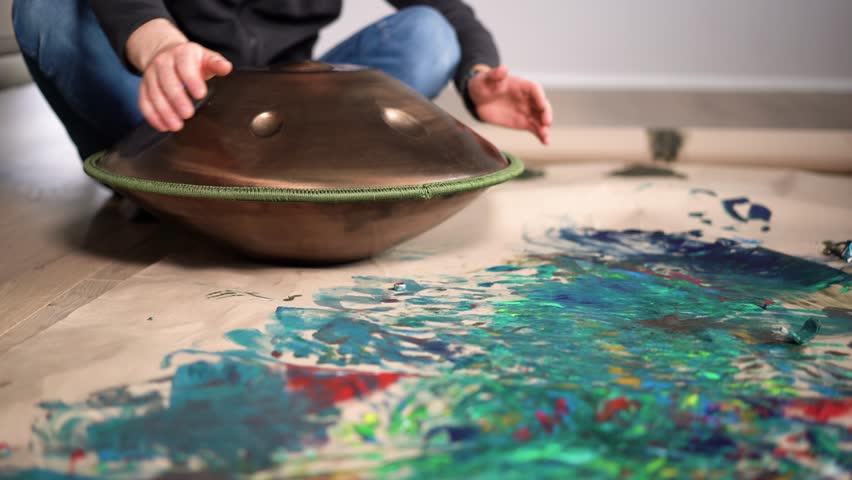 Hands with hang drum close up, man practicing meditation music 