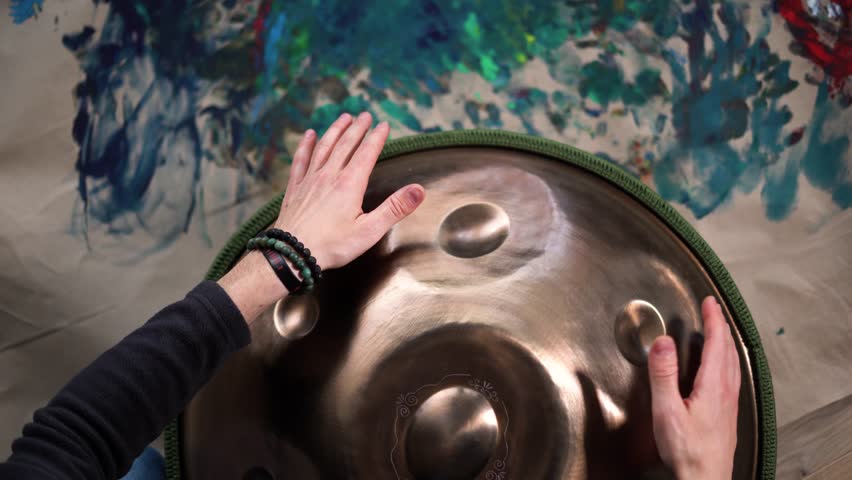 Hands with hang drum close up, man practicing meditation music 