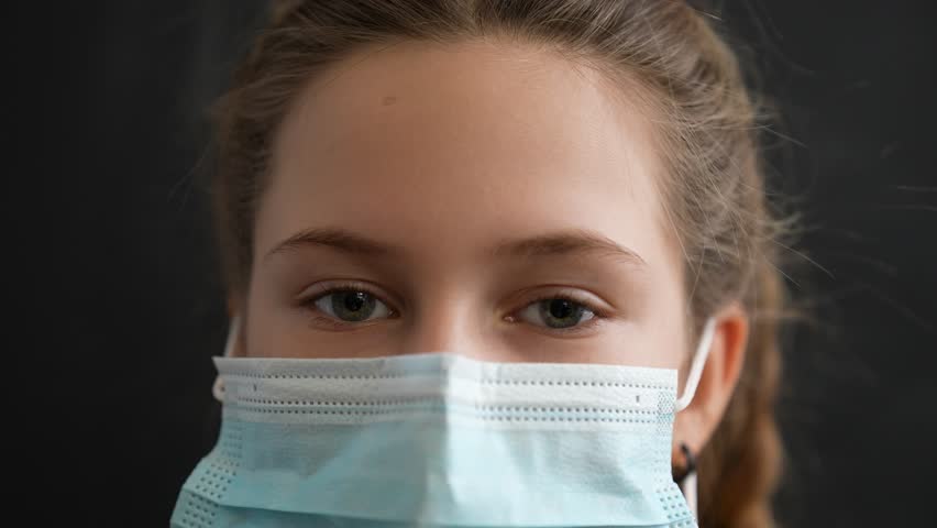 Happy family concept.close up of girls face in medical mask.woman looks at camera.face mask protects against virus.girl at home wearing medical mask.protection of respiratory tract from infection Royalty-Free Stock Footage #1111447049