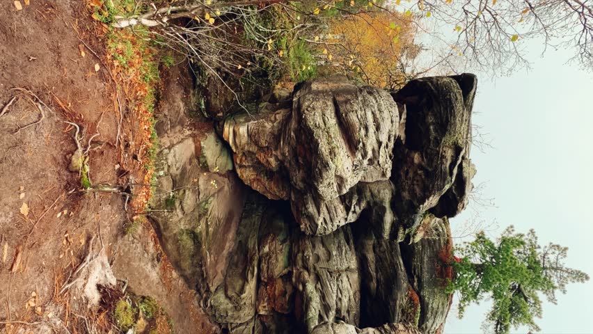 Stone City in autumn. Bright foliage and autumn landscape. The natural landscape is a rock formation in Central Russia, the Urals. A natural monument. Ancient rocky folding in the Ural Mountains. 4K