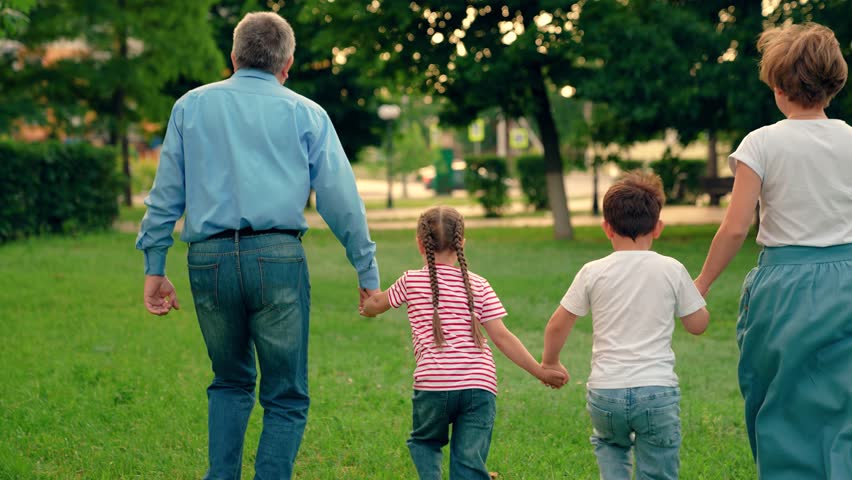 Family game Concept, father mother daughter son fun running. Happy family team, children, parents, run together in park on grass. Children dream, mom dad children in nature. Weekend play, holiday kids Royalty-Free Stock Footage #1111451181