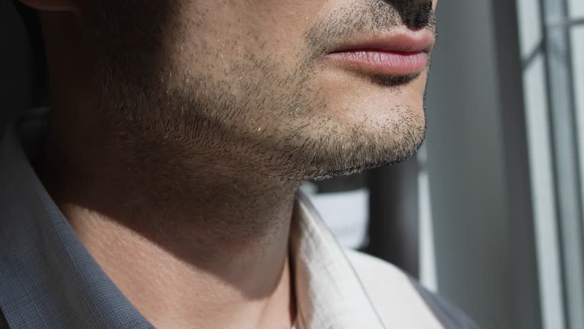 Male unshaven face in a front of the window | Shutterstock HD Video #1111452885