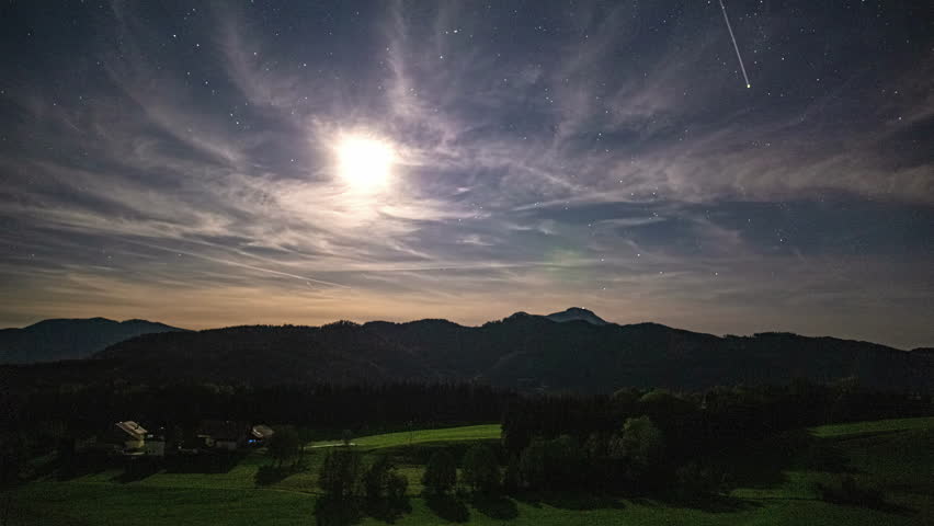 Bright moon and stars over the Austrian alps - time lapse