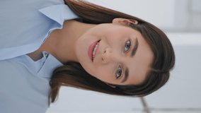 Smiling businesswoman looking camera closeup. Happy manager touch hair posing in white contemporary business center vertical video. Joyful woman artist working in art gallery. Confident entrepreneur. - Powered by Shutterstock - Get 15% off with code: PIKWIZARD15