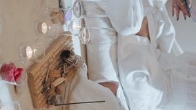 Closeup burning aroma sticks in living room. Women friends hang out in evening with wine glasses vertically video. Unrecognized girls celebrating birthday resting in hotel spa. Aromatherapy concept. - Powered by Shutterstock - Get 15% off with code: PIKWIZARD15